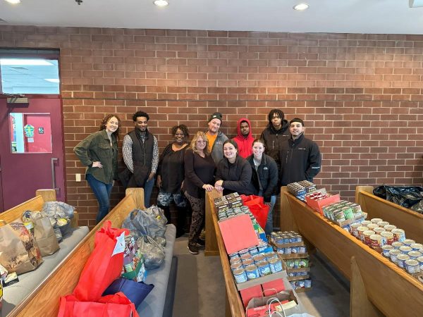 BPG Cares 2024 Holiday Food Drive - Neighborhood House Team and BPG Associates with donations